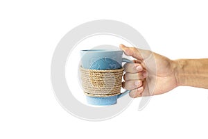 Hand holding a rope wrapped coffee mug