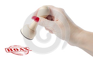 Hand holding a rubber stamp with the word hoax photo