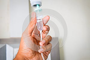 hand holding saline IV drip