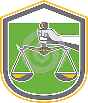 Hand Holding Scales of Justice Shield Retro
