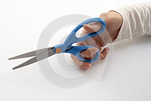 A hand holding scissors