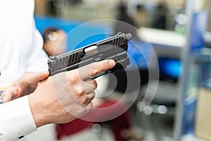 hand holding a semi automatic handgun
