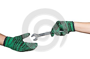 hand holding and sending the wrench on white background. industrial equipment