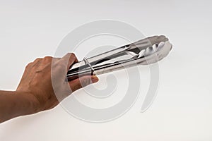 Hand holding Serving kitchen tongs isolated on a white background