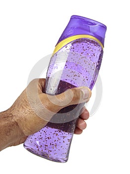 Hand holding shampoo bottle