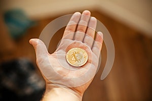 hand holding shiny golden bitcoin, gold money. digital currency, bit coin on people palm, cryptocurrency concept.space for
