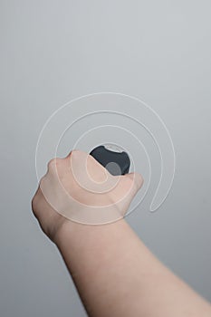 Hand holding shock stun gun on gray background. Electric shocker for self defense photo