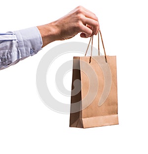 Hand holding shopping bags with christmas shopping on white back