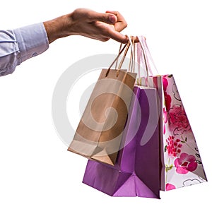 Hand holding shopping bags with christmas shopping on white back