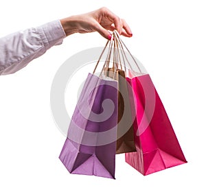 Hand holding shopping bags with christmas shopping on white back