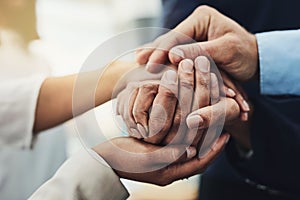 Hand holding showing support, love and care. Close up of a group of people coming together in unity as a team. Friends