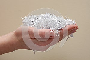 Hand holding shredded paper