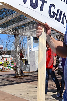 Hand holding sign that says Not Guns at March for Our Lives rally