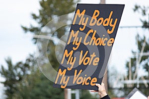 A hand holding a sign supporting pro-choice during a rally for abortion justice. photo