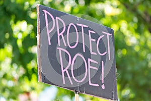 A hand holding a sign supporting pro-choice during a rally for abortion justice.