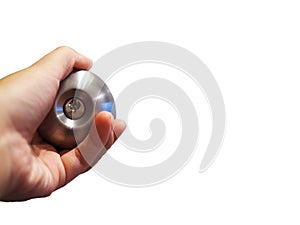 Hand holding silver door knob, white background