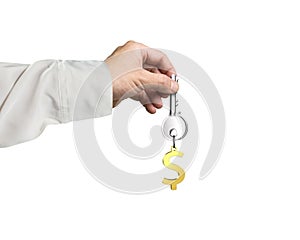 Hand holding silver key with golden dollar sign shape keyring