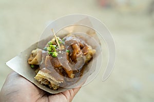Hand holding a simple lumpiang dish