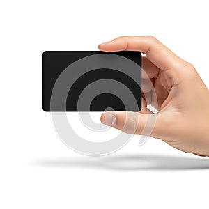 A hand holding a sleek black rectangular object against a white background