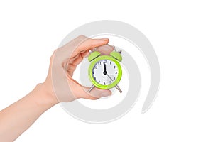 Hand holding a small alarm clock. The concept of time management. Green Alarm clock on a white background. Banner with