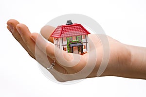 Hand holding small house