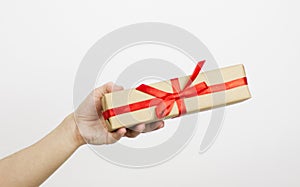 Hand holding small red present box in hands