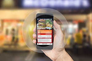 Hand holding smart phone with app food delivery order screen. application for restaurant service