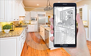 Hand Holding Smart Phone Displaying Drawing of Kitchen Photo Behind