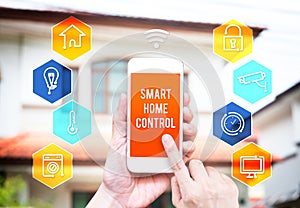 Hand holding smart phone with home control application with blur