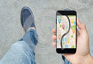 Hand holding smart phone with map gps navigation application.