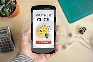 Hand holding smart phone with Pay Per Click concept on screen