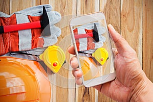 Hand holding smart phone with shoot safety equipment