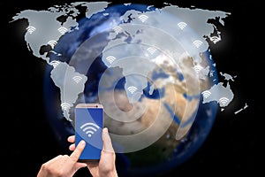Hand holding smart phone on world map network and wireless communication network, abstract image visual, internet