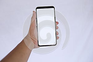 Hand Holding Smartphone with Blank White Screen on light Background