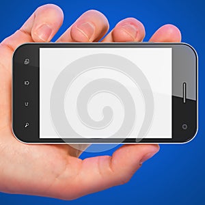 Hand holding smartphone on blue background.