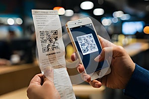 Hand Holding Smartphone near QR Code blurred background emphasizing scanning action photo