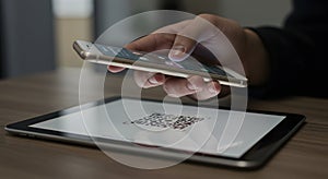 Mobile Payment: Hand Scanning QR Code on Tablet