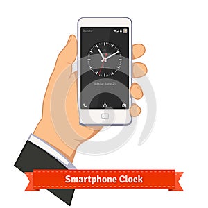 Hand holding smartphone with round clock widget photo