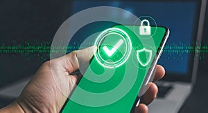 Hand holding smartphone with security icons and binary code