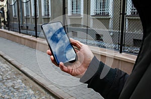 Hand Holding Smartphone Sky Reflection On Street