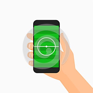 Hand holding smartphone with soccer field on the screen