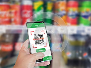 Hand holding smartphone to scan QR code payment , online shopping , cashless concept