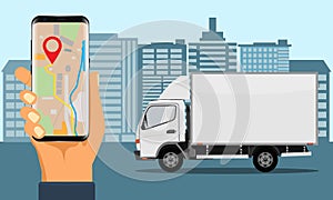 Hand holding smartphone for tracking delivery. City skyline and truck.