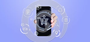 Hand holding smartphone with virtual shopping cart and tech icons on blue background