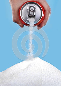 Hand holding soda can pouring a crazy amount of sugar in metaphor of sugar content