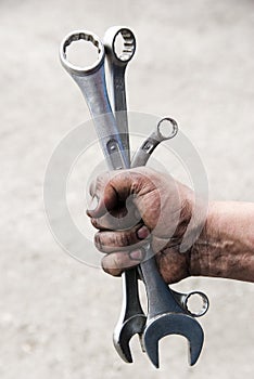 Hand holding spanners