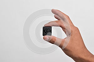Hand holding a spy camera, Black security camera