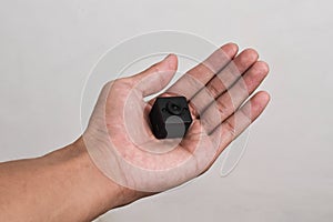 Hand holding a spy camera, Black security camera