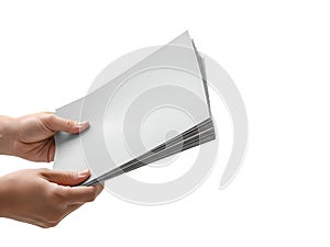 Hand holding a stack of white paper sheets