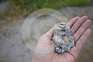 Hand holding stacked pebbles